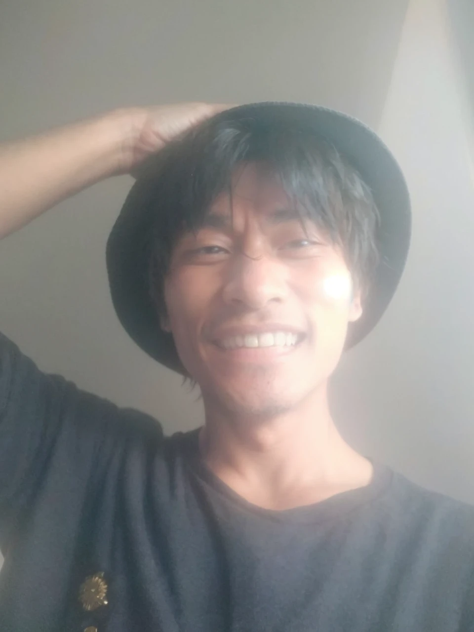 Luffy has black shaggy hair, round black eyes, and a slim muscular build. He is renowned for his trademark straw hat, which was lent to him when he was young by the legendary pirate captain, "Red-Haired" Shanks,[35] who in turn received it from Gol D. Roger.[43] Luffy wears an open, long-sleeved red cardigan with four buttons, with a yellow sash tied around his waist (somewhat reminiscent of Gol D. Roger's outfit). Luffy also has a (scar underneath his left eye), which he earned as a  by stabbing his face to show Shanks that he was tough enough to be a pirate.[44]
