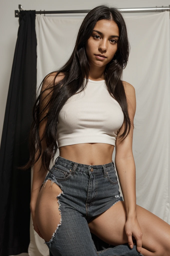 a young woman in her twenties, with Latino and Italian features. She has dark skin and long, straight black hair that falls loosely over her shoulders.  His facial expression is neutral, with no smile or apparent emotion. It was taken with a studio camera. The background is completely white