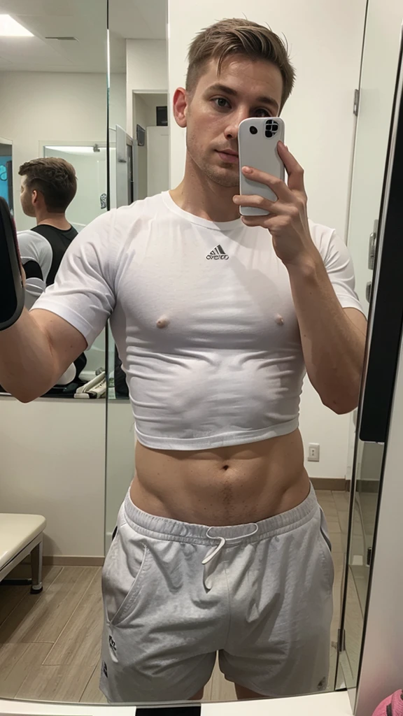 white male, shorth hair, in a shirt at the gym, medium body taking a selfie in the mirror