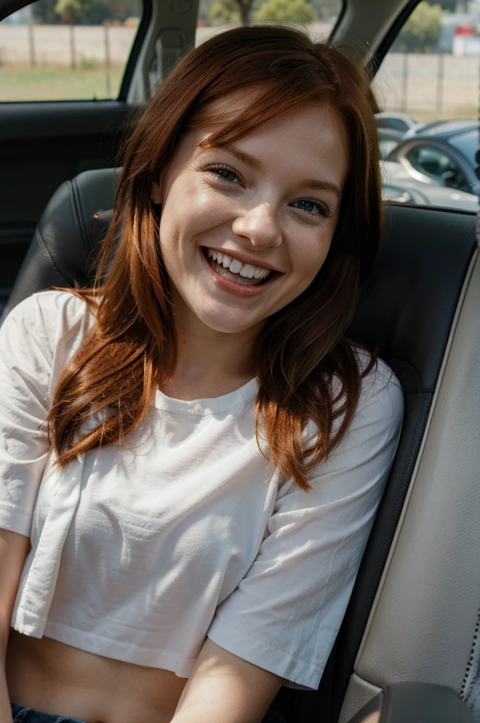 Very young redhead laughing in the car