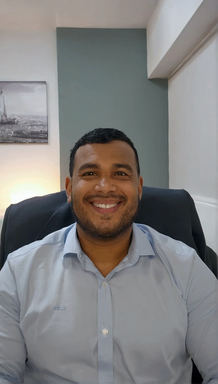 man sitting in blue shirt,Grinning