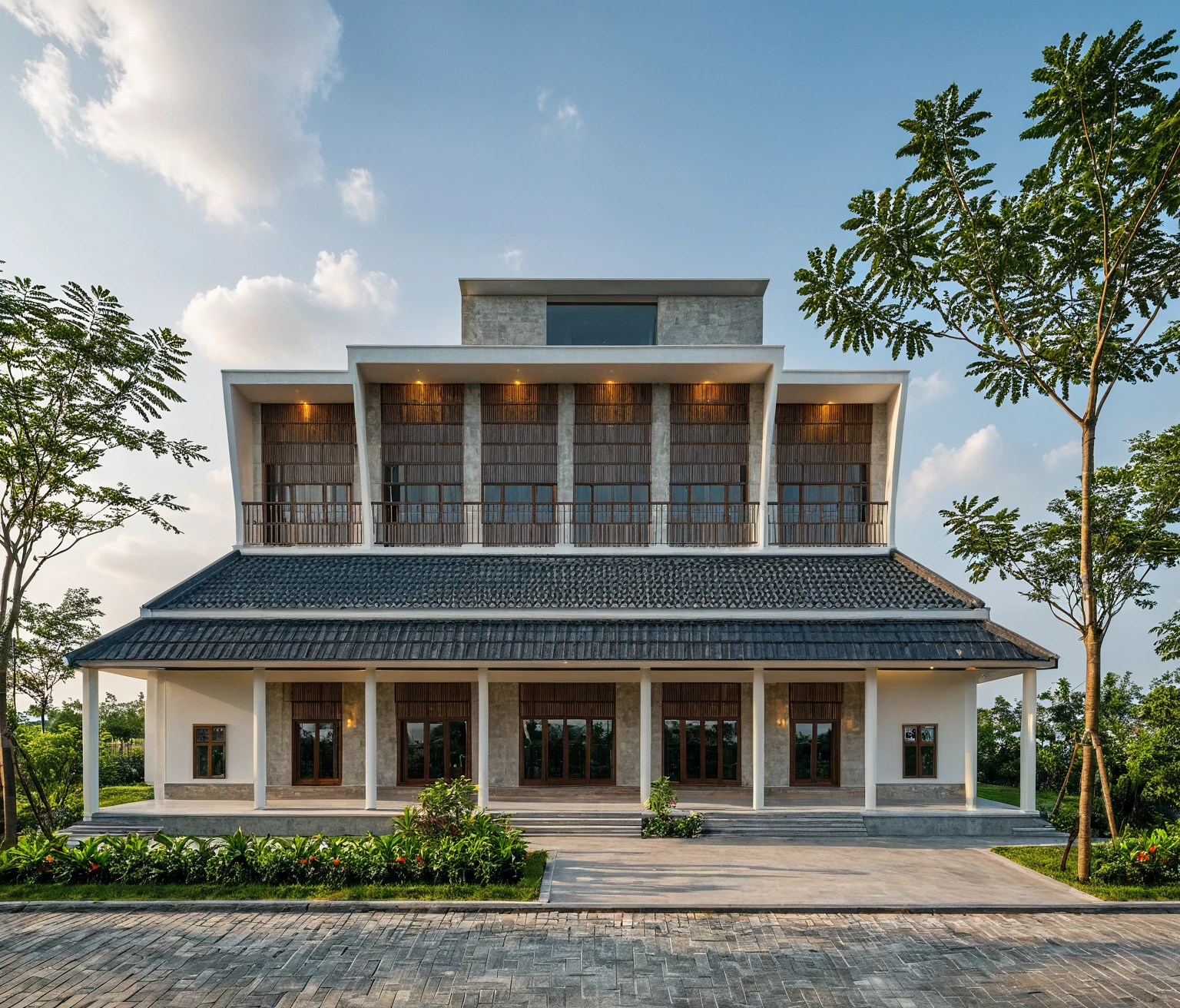 Picture a modern countryside villa exterior in Vietnam, featuring a sloped roof, ((stone)), traditional Vietnamese elements, a spacious courtyard with expansive green lawns, and tropical trees, surrounded by a lively morning atmosphere filled with genuine sunlight, Photography, use a wide-angle lens on a professional-grade camera to capture the authenticity of the scene, RAW photo, (high detailed skin:1.2), 8k UHD, DSLR, soft lighting, high quality, film grain, Fujifilm XT3 A traditional Vietnamese single-story villa exterior, sloping roof, black roofing, white walls adorned with wood and stone accents, serene design, masterpiece, best quality, clear sky, cloud, (nature light), (daylight:1.2)