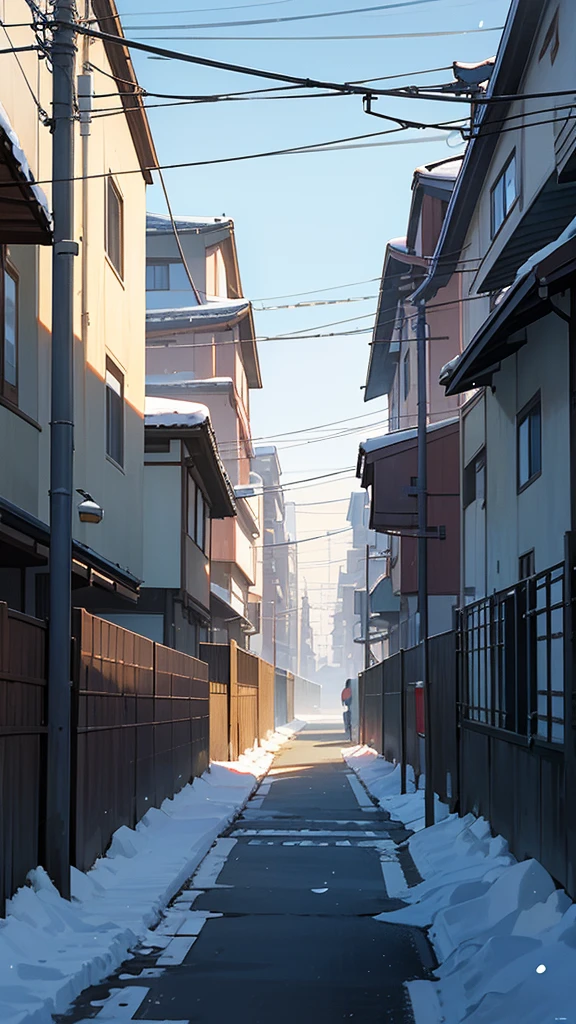 A residential street scene in winter with snow on the sides of the road and rooftops, clear blue skies, and utility poles lining one side of the street, including Japanese signage and architecture.
