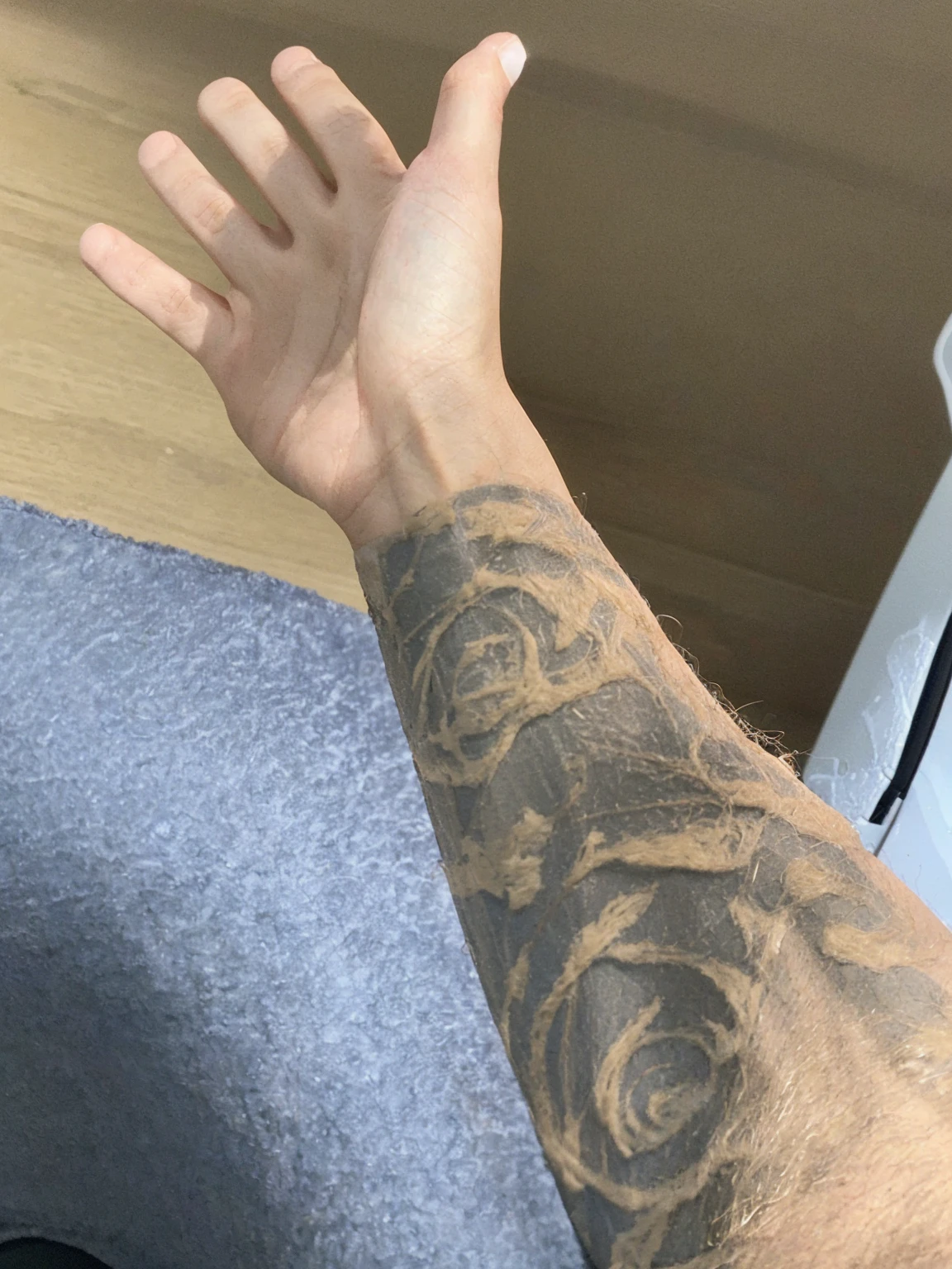 "Create an image depicting a person's arm, taken from the provided reference image, opening the door of a Lamborghini. Ensure the arm is accurately rendered to match the provided image, including skin tone and any distinctive features. The Lamborghini should be shown in detail, with a focus on the luxury and design of the car. Position the arm in a realistic manner, as if it is grasping the door handle and pulling the door open. The background should complement the scene, emphasizing the high-end and dynamic nature of the moment."
