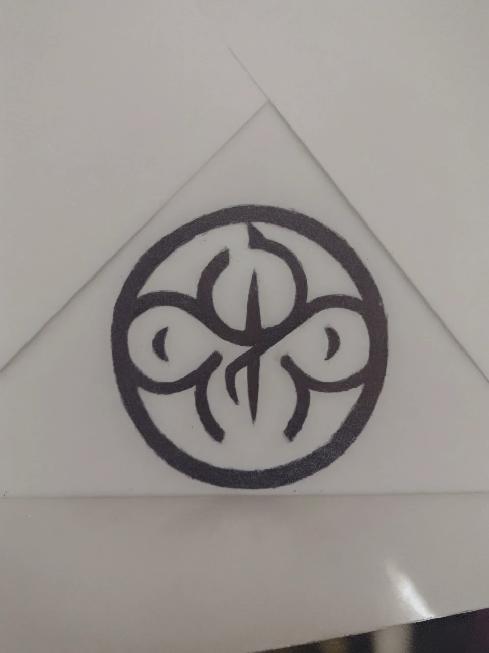 A circular, black symbol with a white background