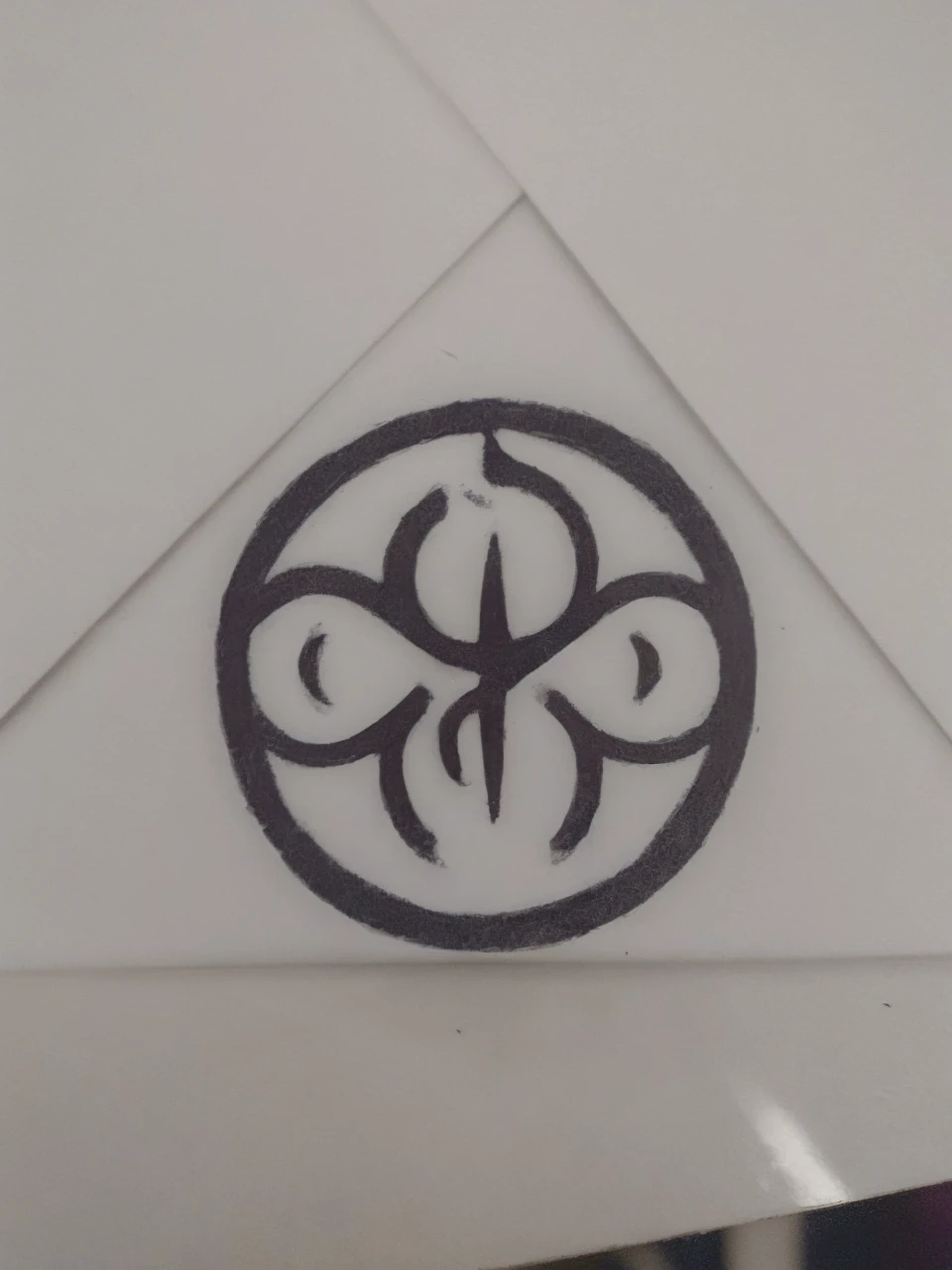 A circular, black symbol with a white background