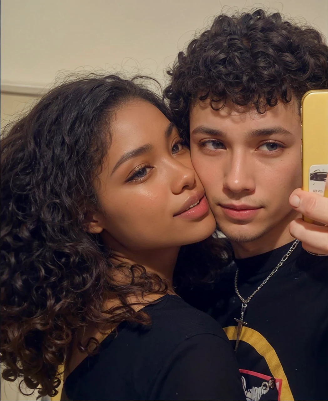 A white man with a goatee and eyes half-closed with a serious expression holding his cell phone looking at the camera and his girlfriend the black woman with her face pressed to his and smiling and she has small eyes.