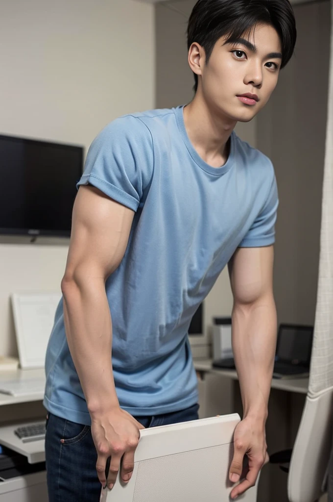 A young Asian man stands, handsome, muscular, looking at the camera. In a simple navy blue T-shirt., In the computer room