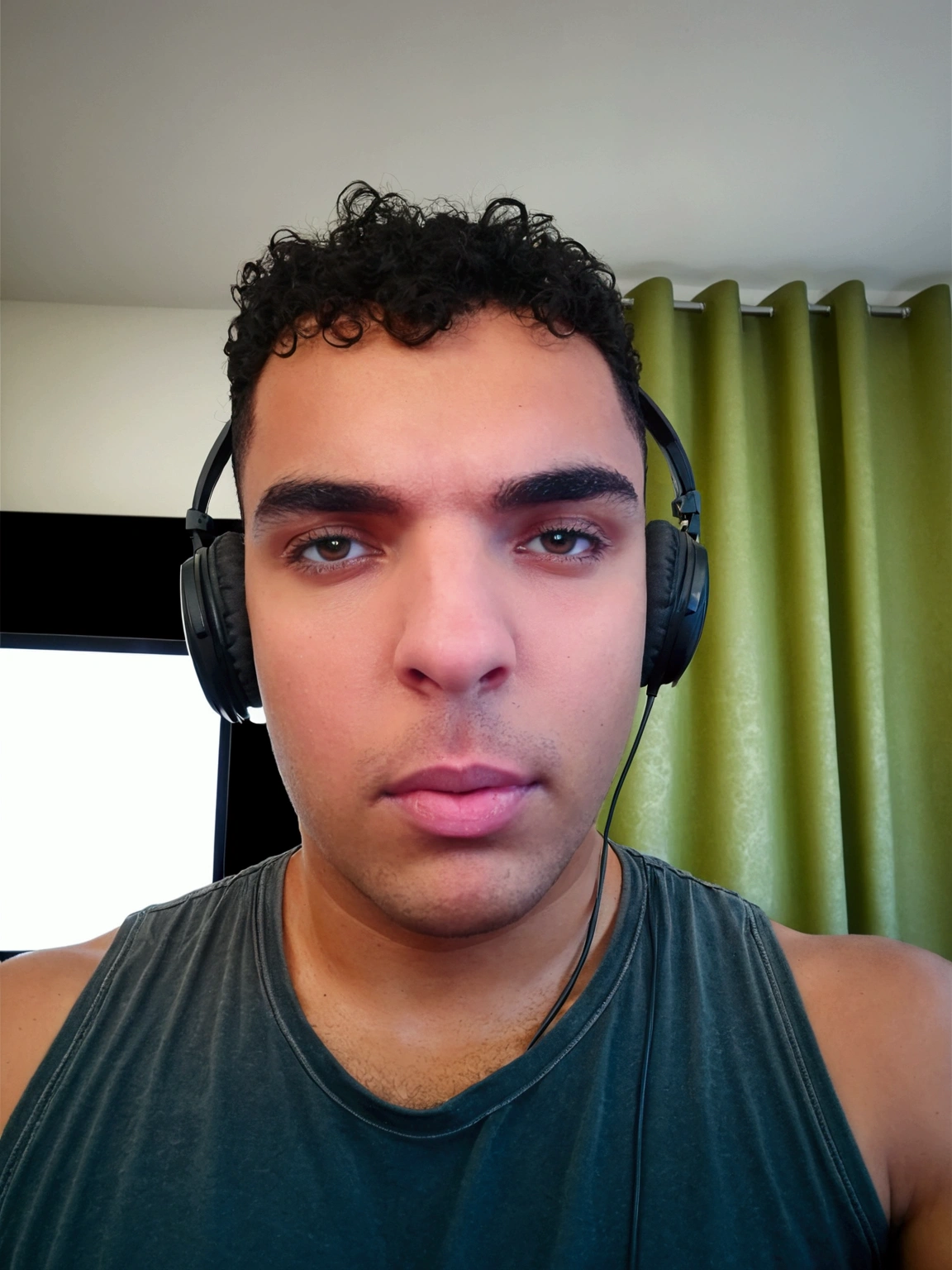 Youtuber headphones in front of computer  