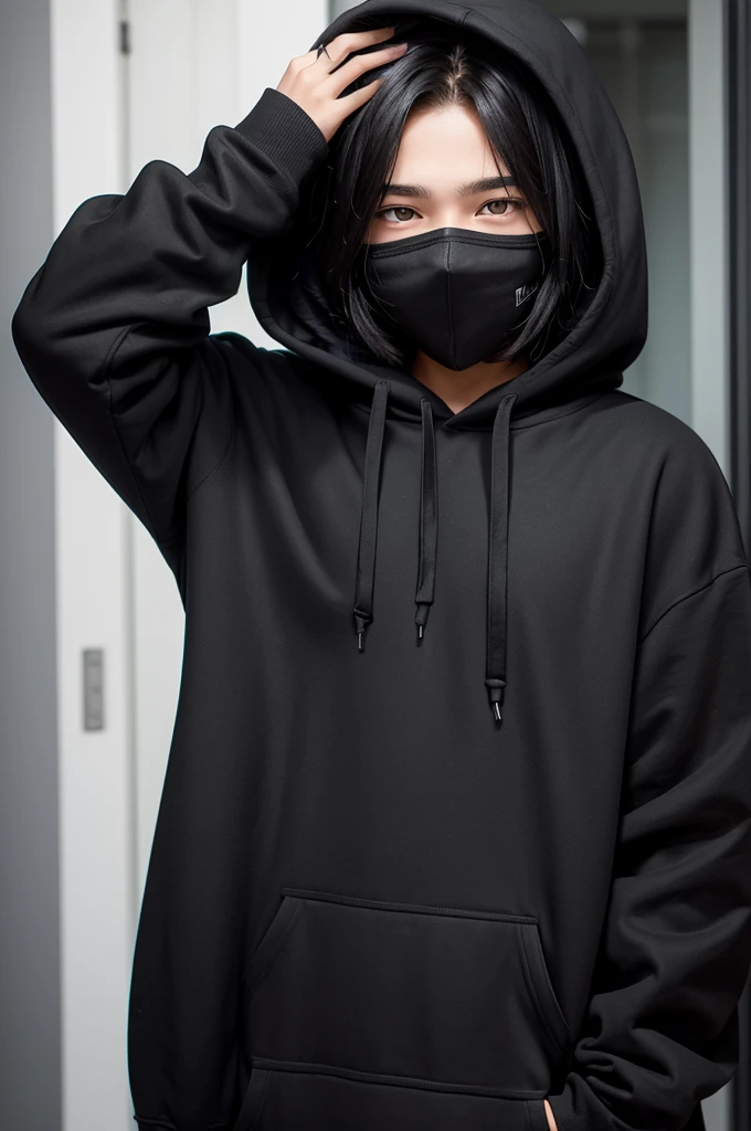 A teenager covering his face wearing a black hoodie. Brown eyes and straight black hair.