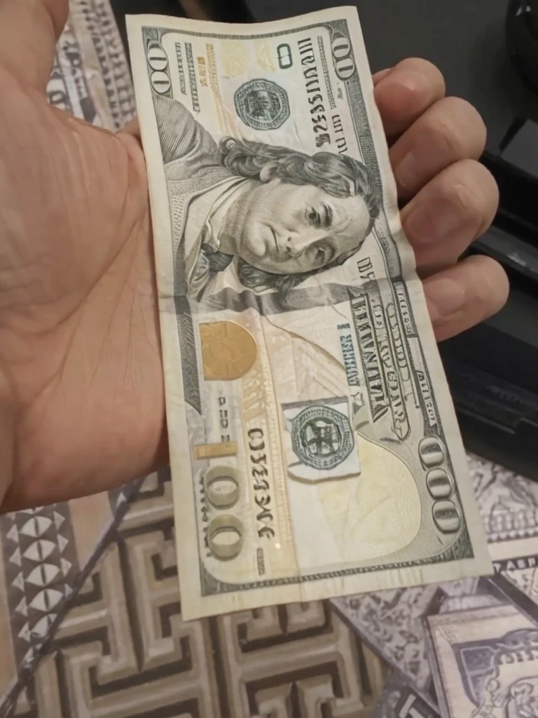 Convert this one 100 dollar bill to 50 bills but keep the background and everything else same