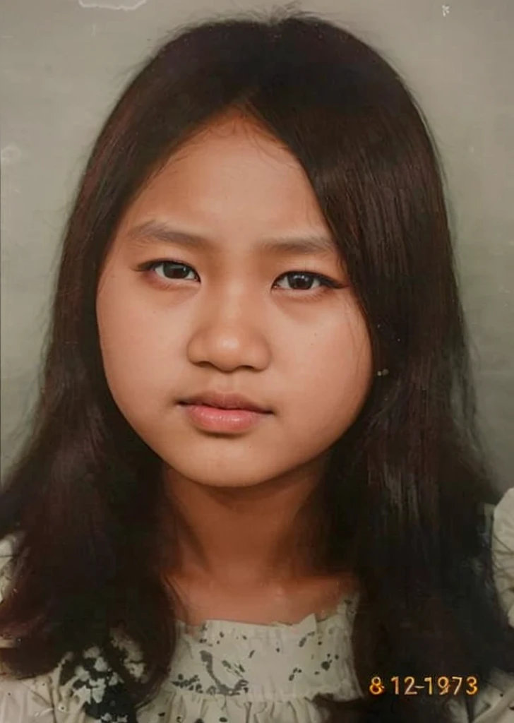color photo, close up. A young Indonesian girl aged 12 years, black hair, wearing a white dress. dark black background studio photo, 8k, ultra HD
