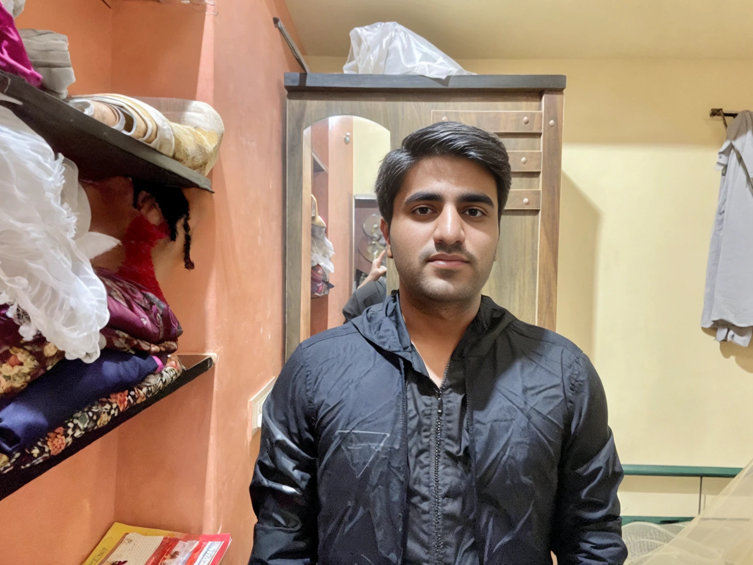 25 year young Pakistani man ultra realistic portrait wearing black formal suit , Apple laptop on table , home background , look at front camera — v 4 ultra HD 8k