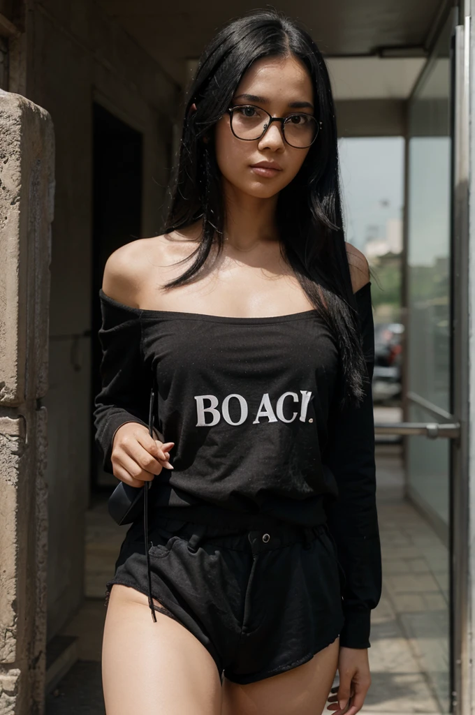 The woman has rather long black hair and is wearing a black shirt with the words "bacot" on it and is wearing black shorts and wearing black glasses
