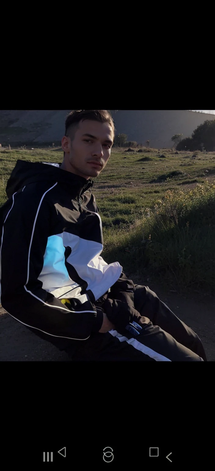 A guy in a tracksuit and a jacket half open
