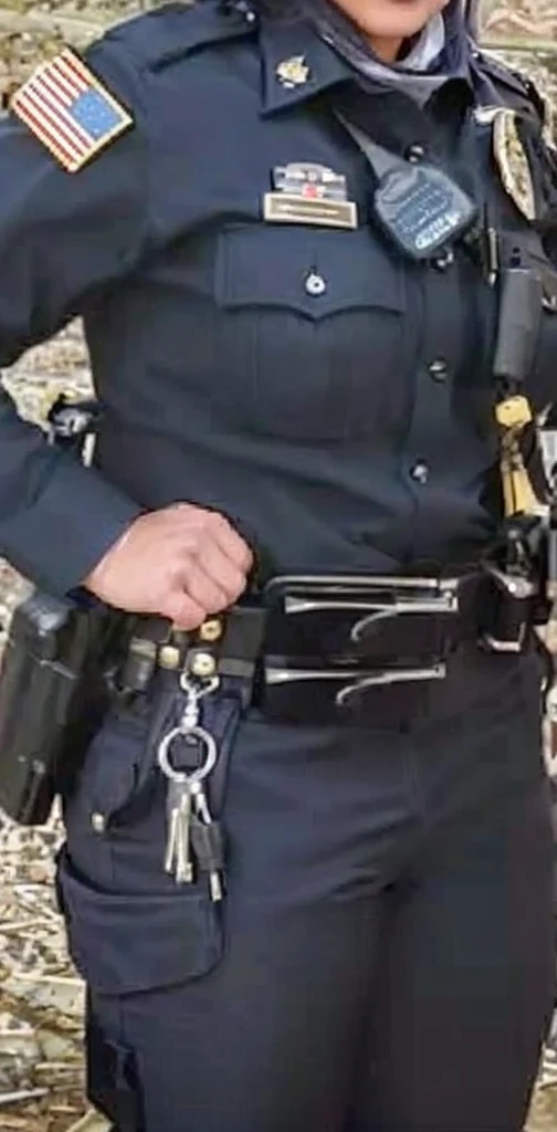 A hot thick muscular sweet sexy Asian American female police officer of the Tonka City police department All dressed in her dark police uniform 🥋 and she is posing for a professional photo op with the Tonka telegram for the community.