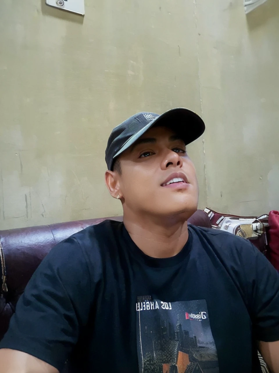 ((masterpiece)), ((best quality:1.2)), High Resolution, 8k, (ultra_realistic:1.3), (photorealistic:1.4), (instagram model, handsome:1.2), sharp focus, a close up photo of (Ronnie Alonte, ronniealontekm), wearing black tank top, curly hair with undercut, outdoors, urban, city, buildings in the background,