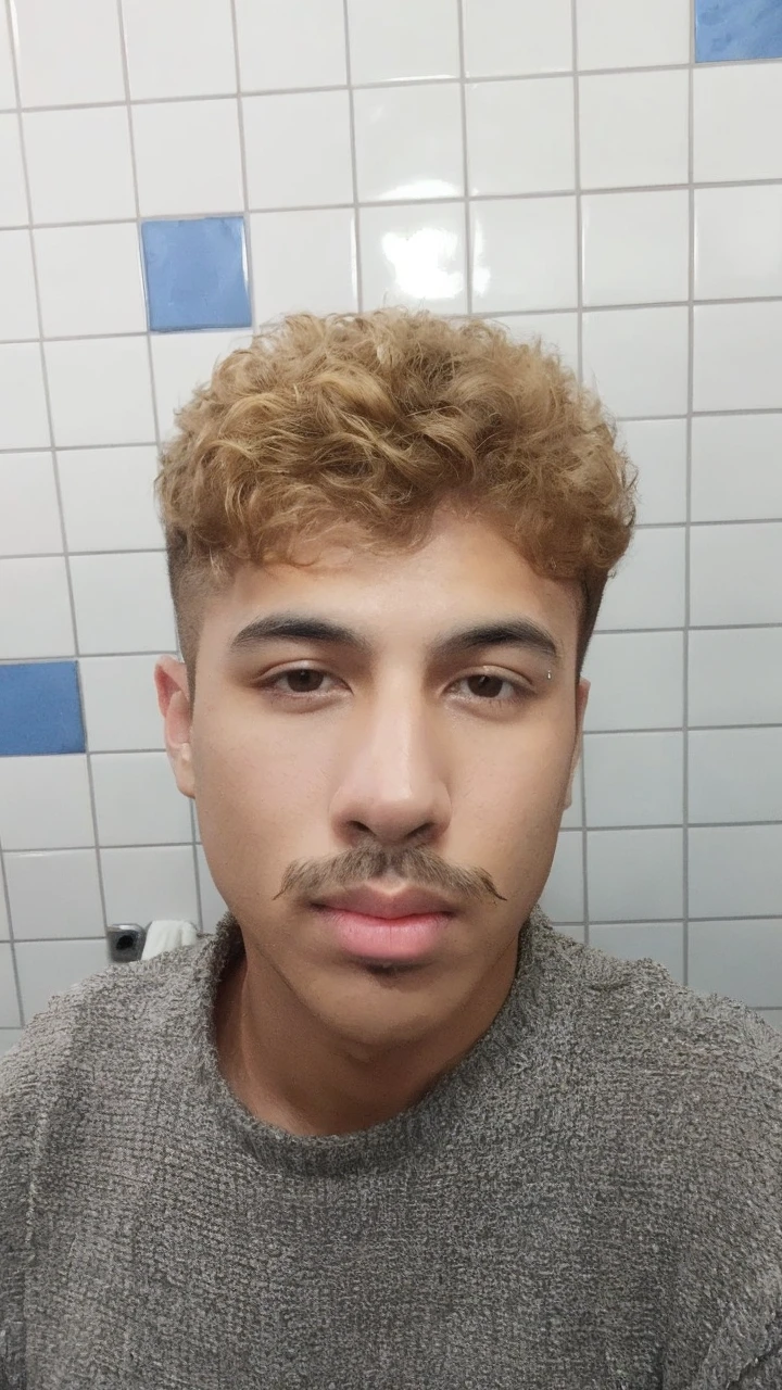 handsome brown man with mustache and short wavy dark blond hair