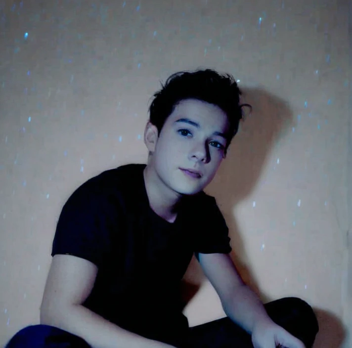 An image of a young and handsome boy with light blue hair gazing up at the starry night sky during winter, with shooting stars streaking across the heavens.