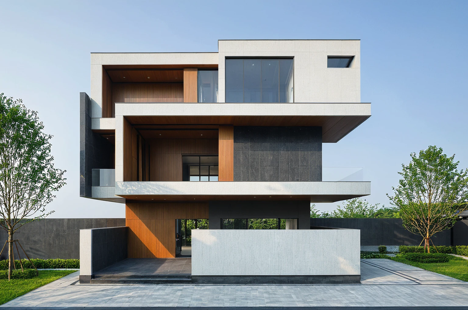 (masterpiece, best quality:1.2), exterior design, single 2 storie modern house on the Vietnam village, modern dark tiled granite and white walls facade, wooden ceiling, large glass, minimalist modern style, green shrubs and tropical tree background, ((natural light)), clear sky morning background, large door and windows,