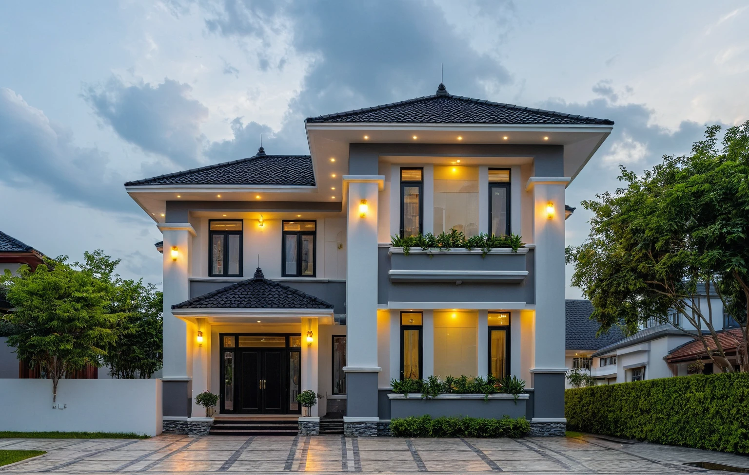 (masterpiece:1.2), best quality, photo of A two-story modern house in VietNam with white walls and dark tiles on the roof., tree and plant environment,daylight, streetcapes, natural light, vivid color, The exterior of an elegant single family home features large windows, a dark gray door frame.