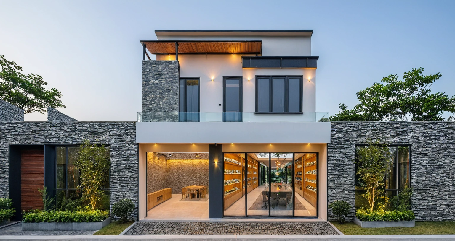 Two-story townhouse, Minimalist architecture, modern house, brightly painted walls, stone wall accents, xingfa aluminum glass doors. The canopy is made of durable iron glass. Vào buổi chiều, Construction lights are turned on and you can see the furniture, The first floor is where the business is located, The second floor is the residence. actual representation. surreal house