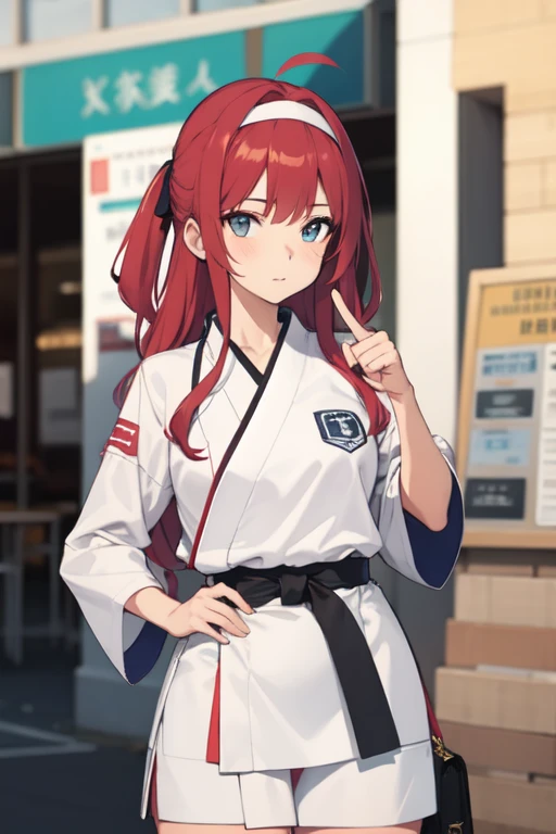 A girl wearing a karate uniform and a headband