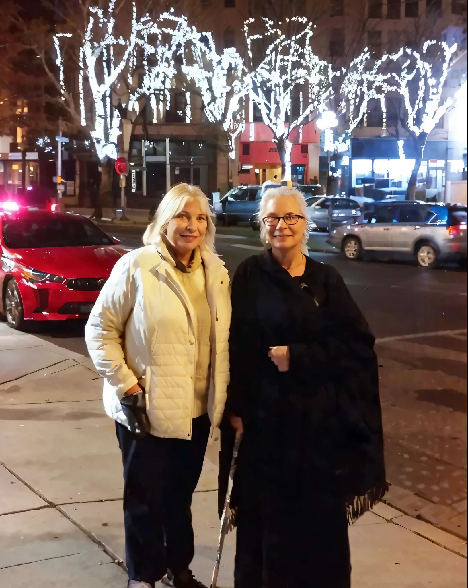 two women standing on a sidewalk in front of a building, by Kathleen Scott, photo taken at night, at a city street, by Bernie D’Andrea, in an urban setting, standing on street corner, by Steve Brodner, by Nancy Carline, standing in a city street, in city street at night, by John Armleder, a photo