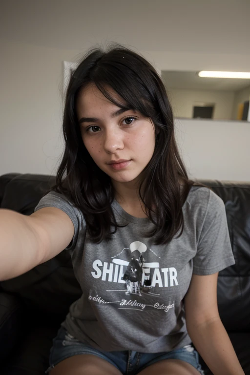 girl with straight black hair taking a selfie sitting at an angle from above wearing a t-shirt