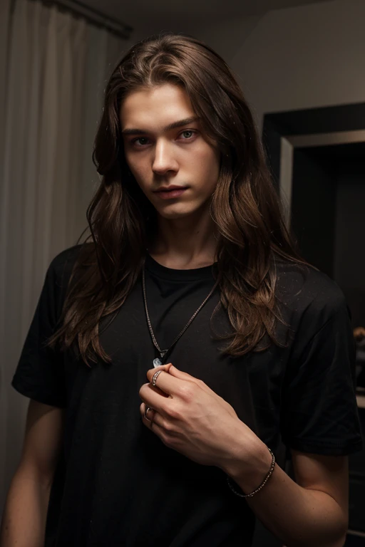 A tall, slender young man, , of Russian type with long curly light brown hair. black shirt. rings on fingers. on the chest there is a metal pendant - half a heart. The eyes are gray-blue
