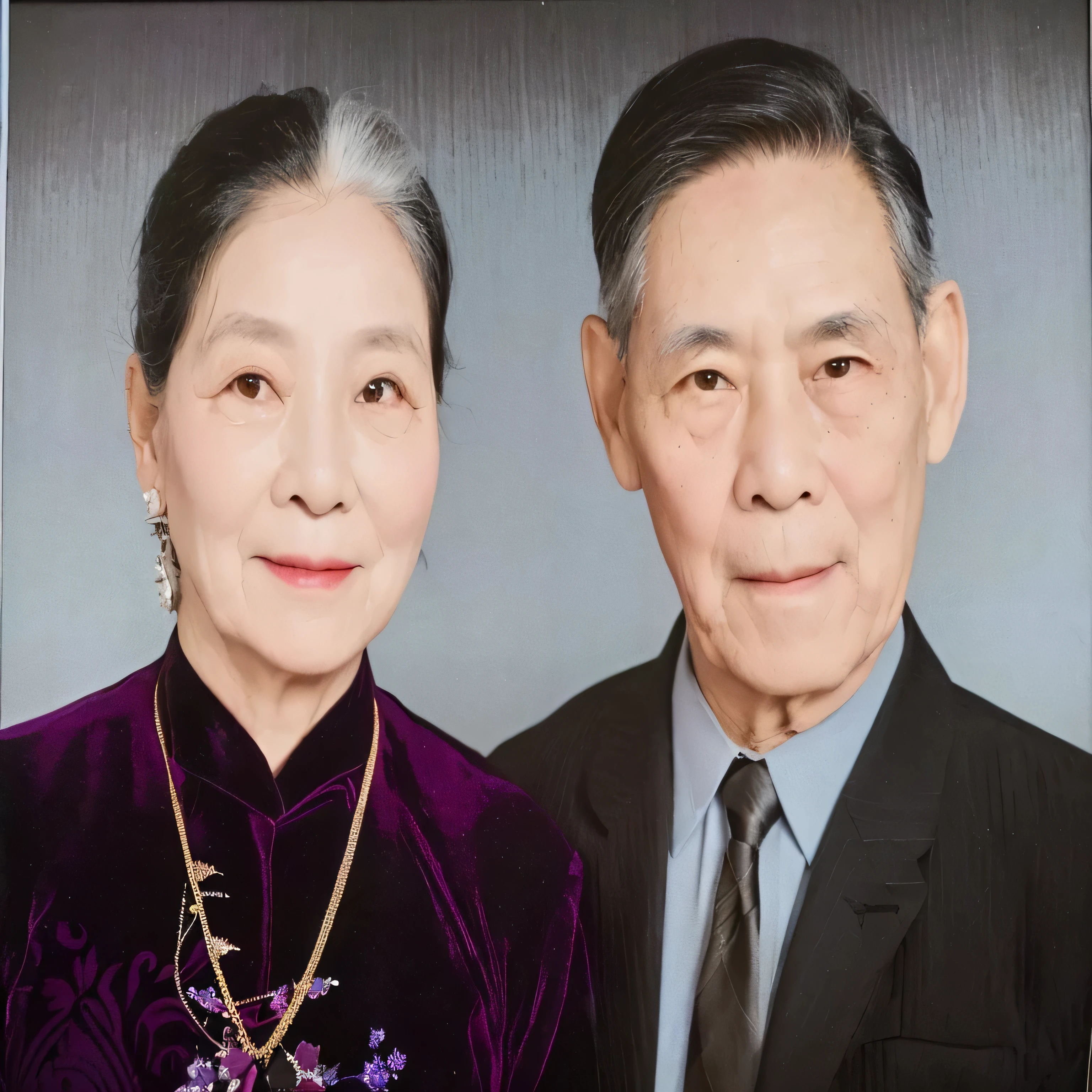 The image features an elderly couple posing for a portrait. The woman is dressed in a traditional purple garment with decorative jewelry, which suggests a cultural or formal attire, often seen in various Asian cultures. The man is wearing a formal gray suit with a neat tie. Their expressions are serene and composed, common in classic, formal portraits. The photo appears to have been colorized, emphasizing details like clothing color and skin tones, which adds a layer of vibrancy and modernity to an otherwise likely older photograph. This type of portrait is typically used to capture significant life moments or for keepsakes within a family.