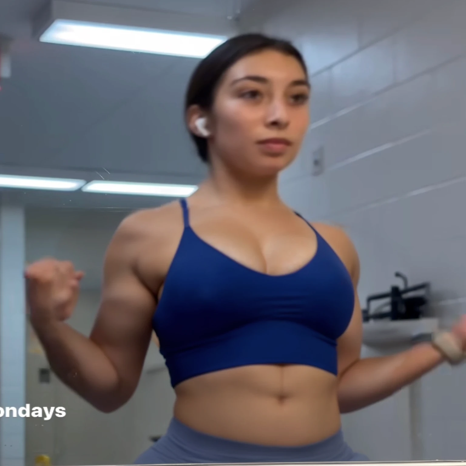 there is a woman in a blue top is standing in a bathroom, violet myers, showing off biceps, chun li at the gym, working out, centered shoulders up view, flexing, crop shirt and strong abs, fit girl, her face flushing and sweat, shoulders up, bursting with muscles, posing and flexing, muscles, shoulders can be seen, Big tits, huge , no clothes, sexy, cute, wide hips, thick thighs, pear-shaped body, minimal clothes, thick, bbw, chubby stomach, thick nipples, nipple piercings, large areola, hard nipples, piercing through shirt, nipples hard through shirt, busty, major cleavage, naked, ripping through top, spilling over sides, bra too tight, giant , dominatrix, dominatrix clothes, huge giant , upper body zoom, only wearing bikini, chubby stomach, massive  and waist