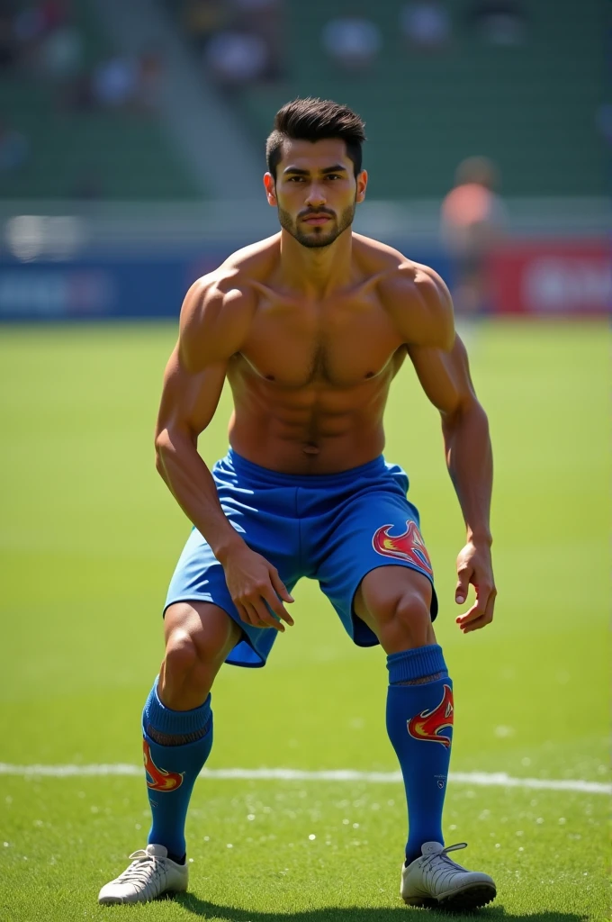 Shirtless Thai soccer player wearing blue soccer shorts with flames and knee high soccer socks squatting 