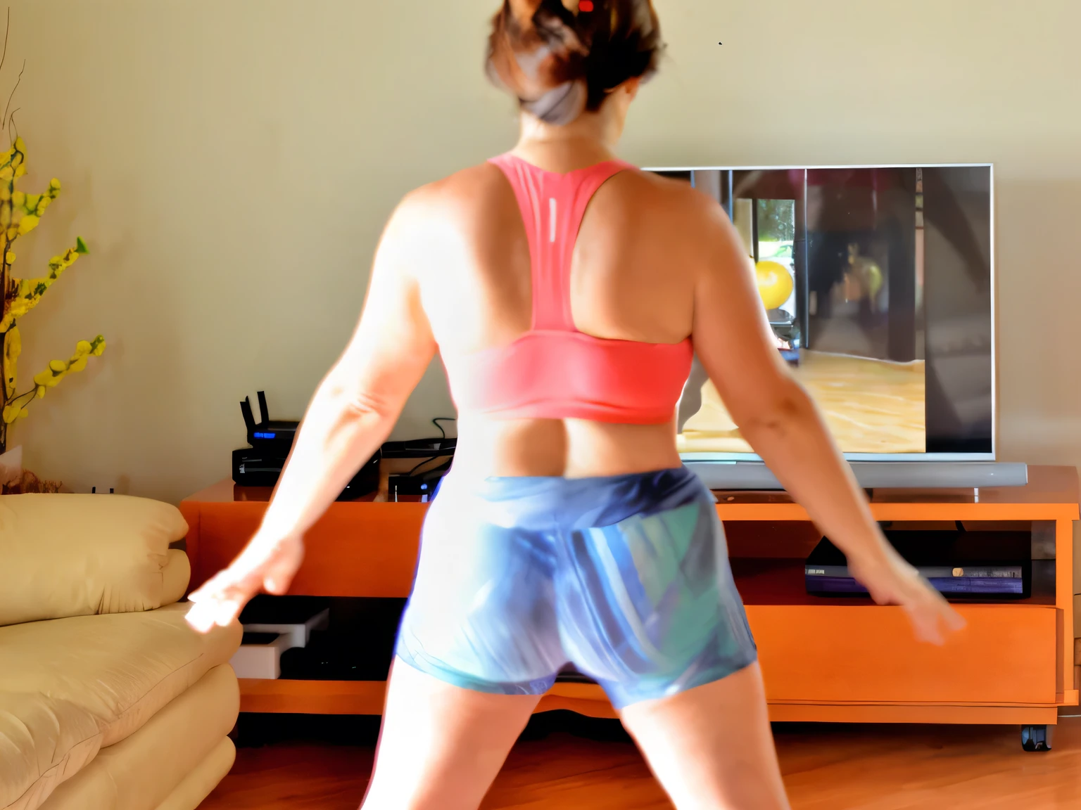 there is a woman in a pink top and blue shorts playing a video game, toned derriere, sport bra and shorts, back pose, shapely toned derriere, back - shot, back shot, from the back, backshot, seen from the back, shot from the back, middle shot waist up, from back, back arched