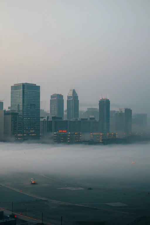 Fog envelops construction site, leaving only the outlines of future buildings visible.