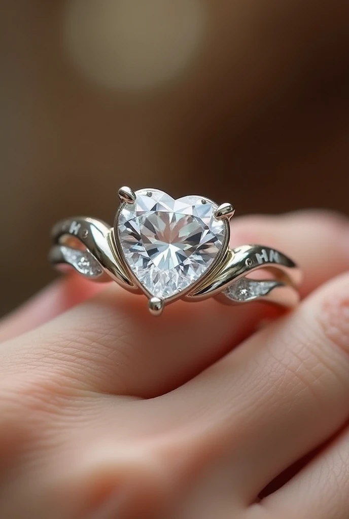 engagement ring, heart cut stone, that has a slight twist, an H engraved on one side of the stone and an M on the other side