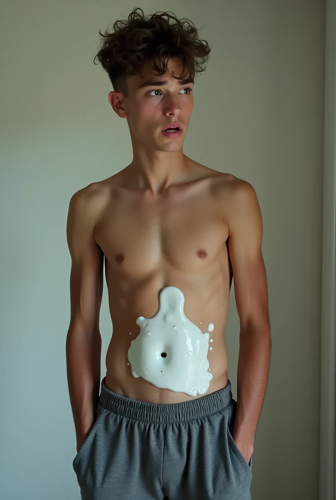 boy in sweatpant having white juice on his abs