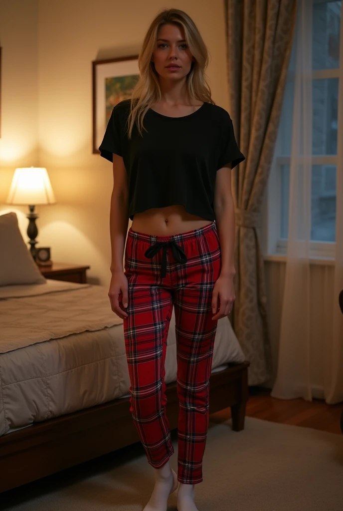 Hot blonde 35 year old woman standing in bedroom wearing black cropped short sleeve shirt and red and white flannel tight pajama pants and short white Nike ankle socks during the night. Zoomed out Full Front view show legs and feet