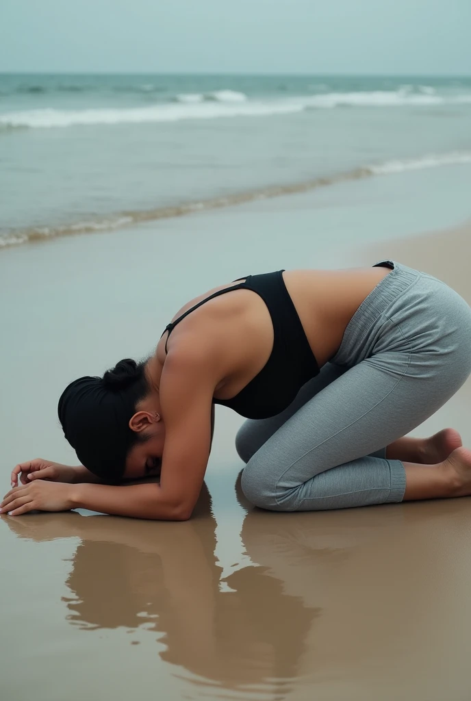 with black headscarf, barefoot, grey sweatpants, braless woman,  lying face down on the beach