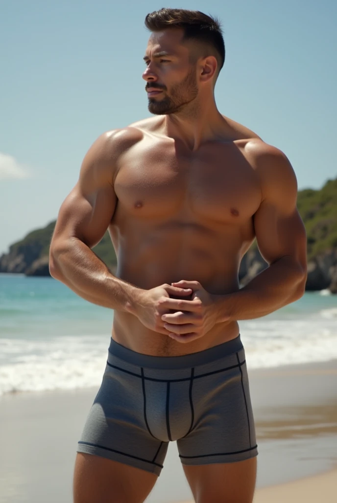 clean shaven muscular man in boxers with his hips jutted forward. large crotch outlined by boxers. low angle shot. at the beach. make it explicit. 