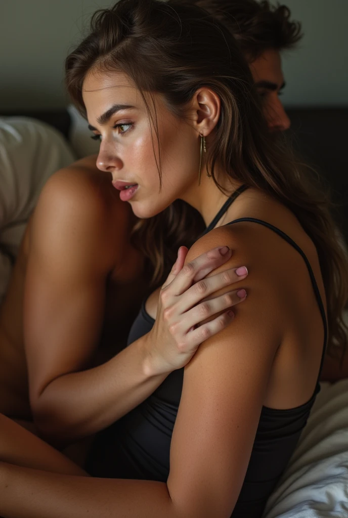 A confident woman, dressed in a luxurious bra and matching underwear with intricate lace patterns and floral designs, stands beside a bed. She has both legs wrapped tightly around the head of a shirtless boy lying on the bed, her thighs pressing firmly against his face. Her legs form a strong, secure hold, keeping his head in place. She uses both hands to grip his wrists tightly, ensuring he cannot move or escape from the position. Her posture is dominant and assertive, showcasing her strength and control. The room is softly lit with warm, ambient light, creating an intimate atmosphere that highlights the intense physical interaction between the two. The bed is neatly made, and the decor is minimalistic, focusing attention on the powerful grip and close contact."