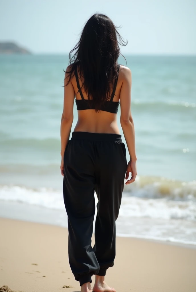 black hair, black sweatpants, Barefoot woman strips completely on the beach