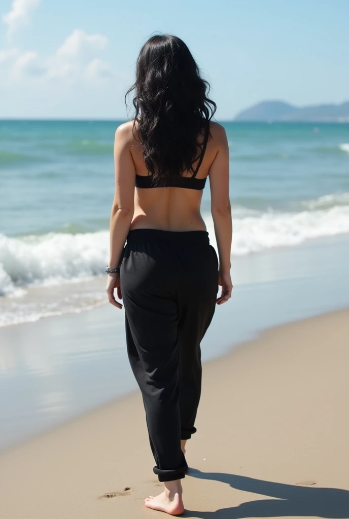 black hair, black sweatpants, Barefoot woman strips completely on the beach