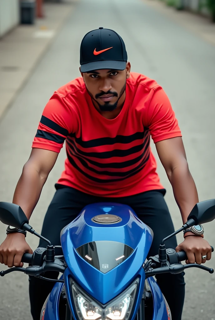 A photo of a man on a blue motorcycle on what appears to be concrete ground wearing a red shirt with black stripes and a black Nike cap with the symbol highlighted