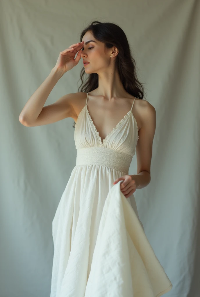 A Woman Holding a White quilt away from her Body with one Hand and covering her eYes with the other Hand gracefully