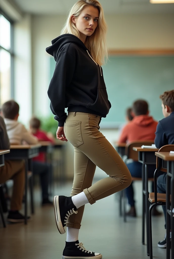 Realistic white girl, blonde hair, blue eyes, butt, tight khaki pants, black high top converse shoes, black hoodie, white socks, one leg kicking in the air towards the camera, classroom background, full body.