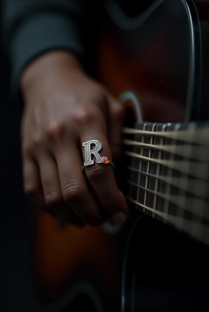 "A dark-themed image focusing on a close-up of a hand playing a bar chord on a guitar. Only the hand and the fretboard are visible, with the rest of the image shrouded in shadow. The hand, illuminated subtly, wears a silver ring on the  midle finger. The ring is intricately designed, featuring a capital letter 'R' with a same size orange gemstone embedded at the end of the letter. Ring  top is not round . Hand is young  boys brown colur hand. Meke to wthsapp dp size.  and ring top not round  R letar and gemstone is seme size