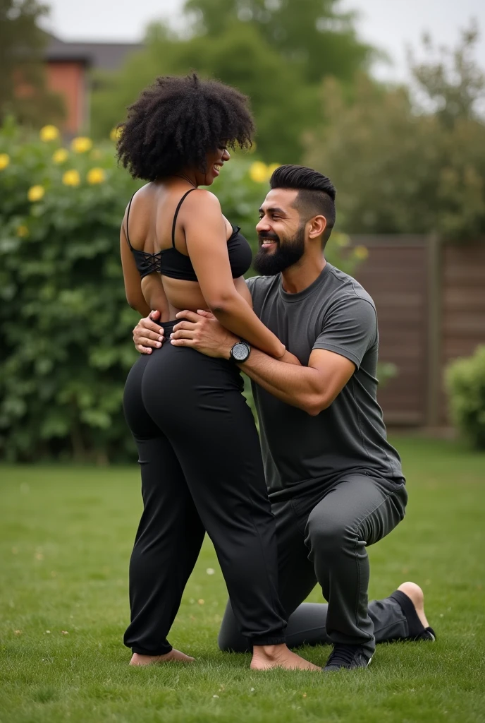 Black hair in the garden, black sweatpants , Barefoot woman. Man pressing woman&#39;s butt from behind