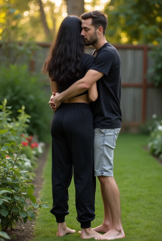 Black hair in the garden, black sweatpants , Barefoot woman. Man hugging woman from behind