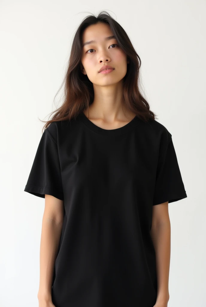 young woman in plain black unisex t-shirt, on a white background.